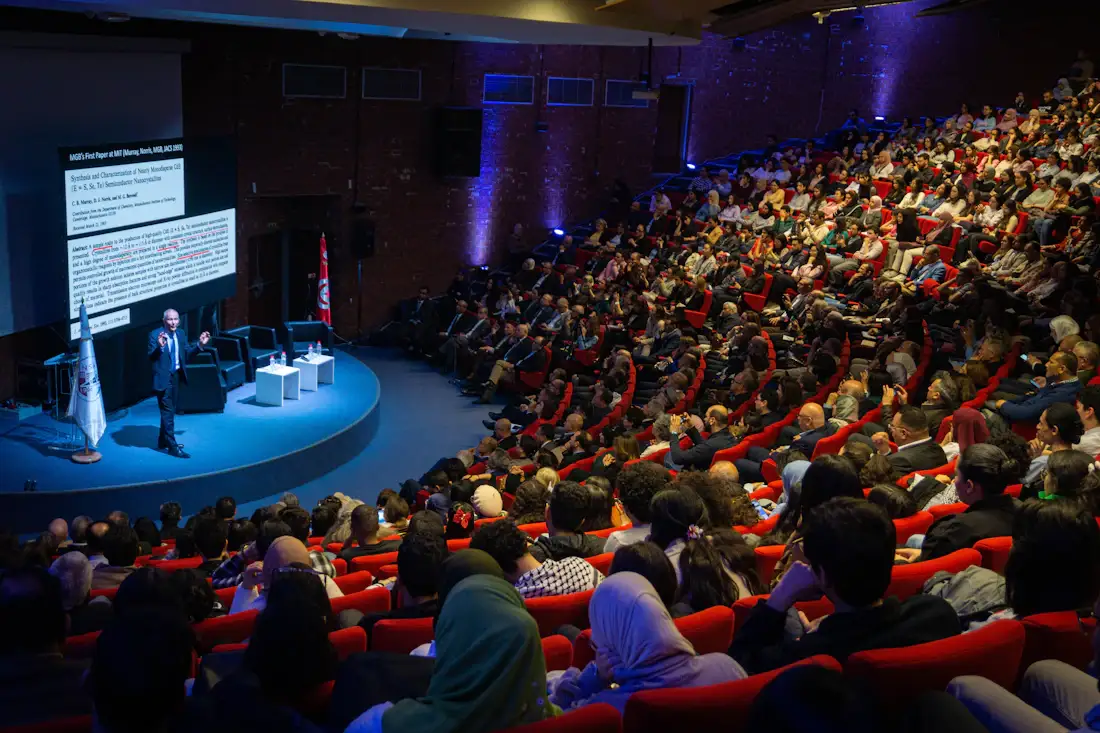 Speaker presenting to a full auditorium