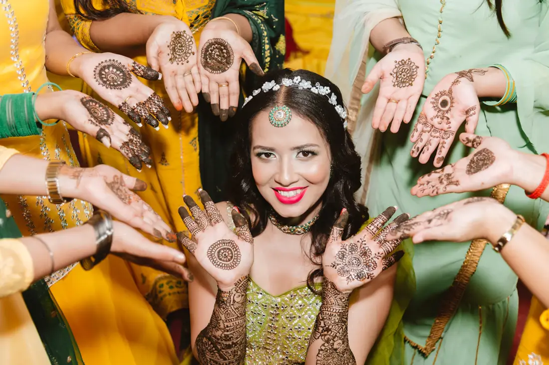 Bride showing mehndi with friends by Events by OT