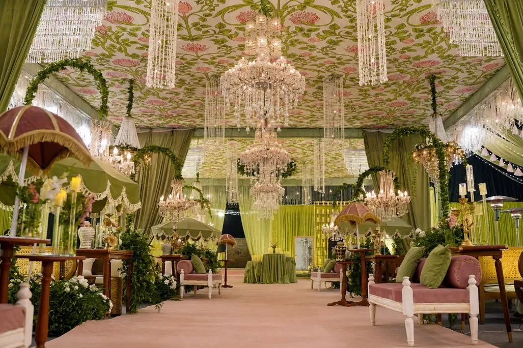 Sage green marquee with crystal chandeliers by Events by OT