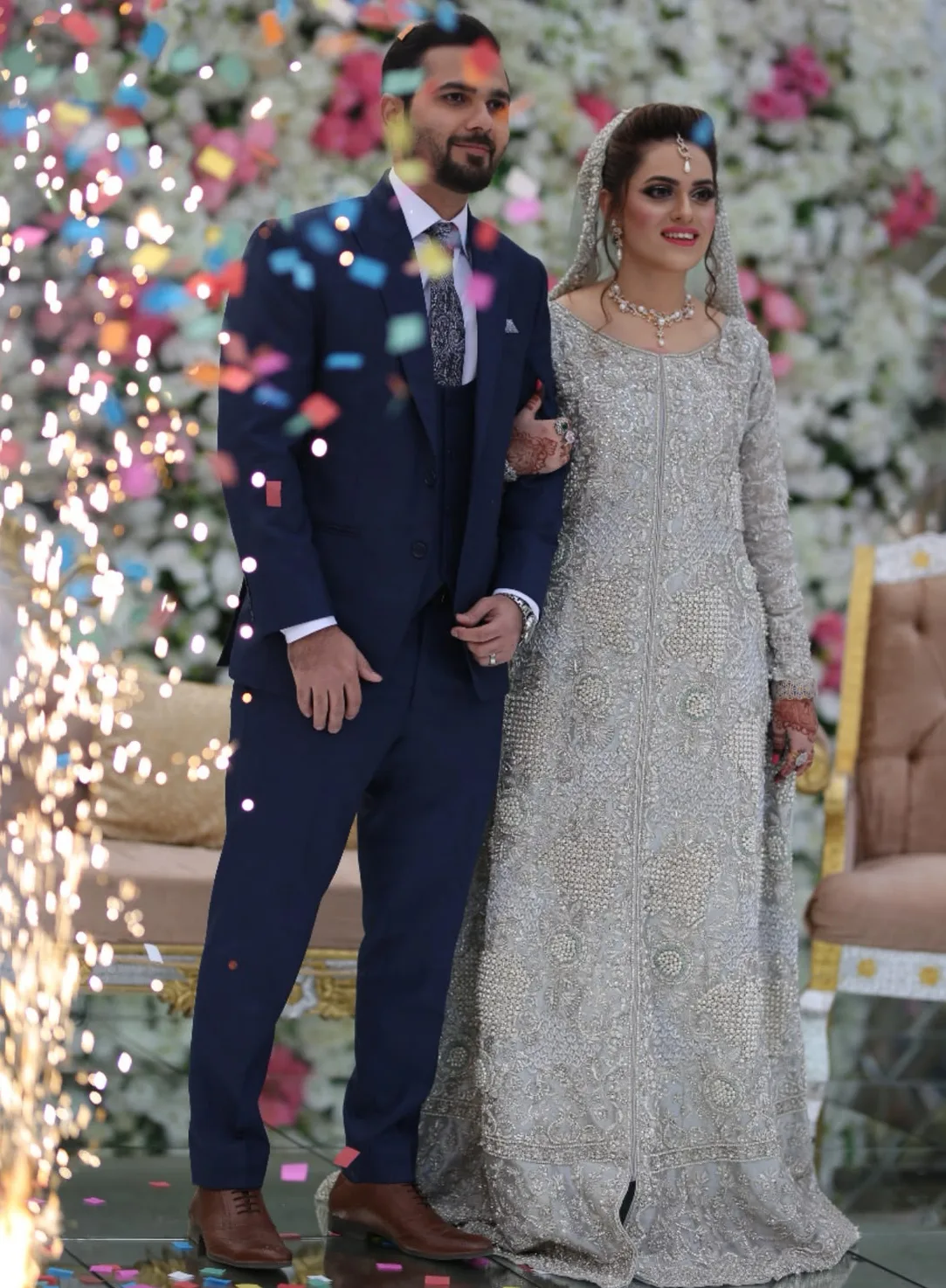 Walima couple on a floral stage with cold-pyro entry