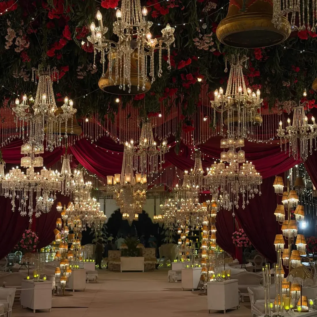 Grand wedding marquee with red velvet and crystal chandeliers in Lahore by Events by OT
