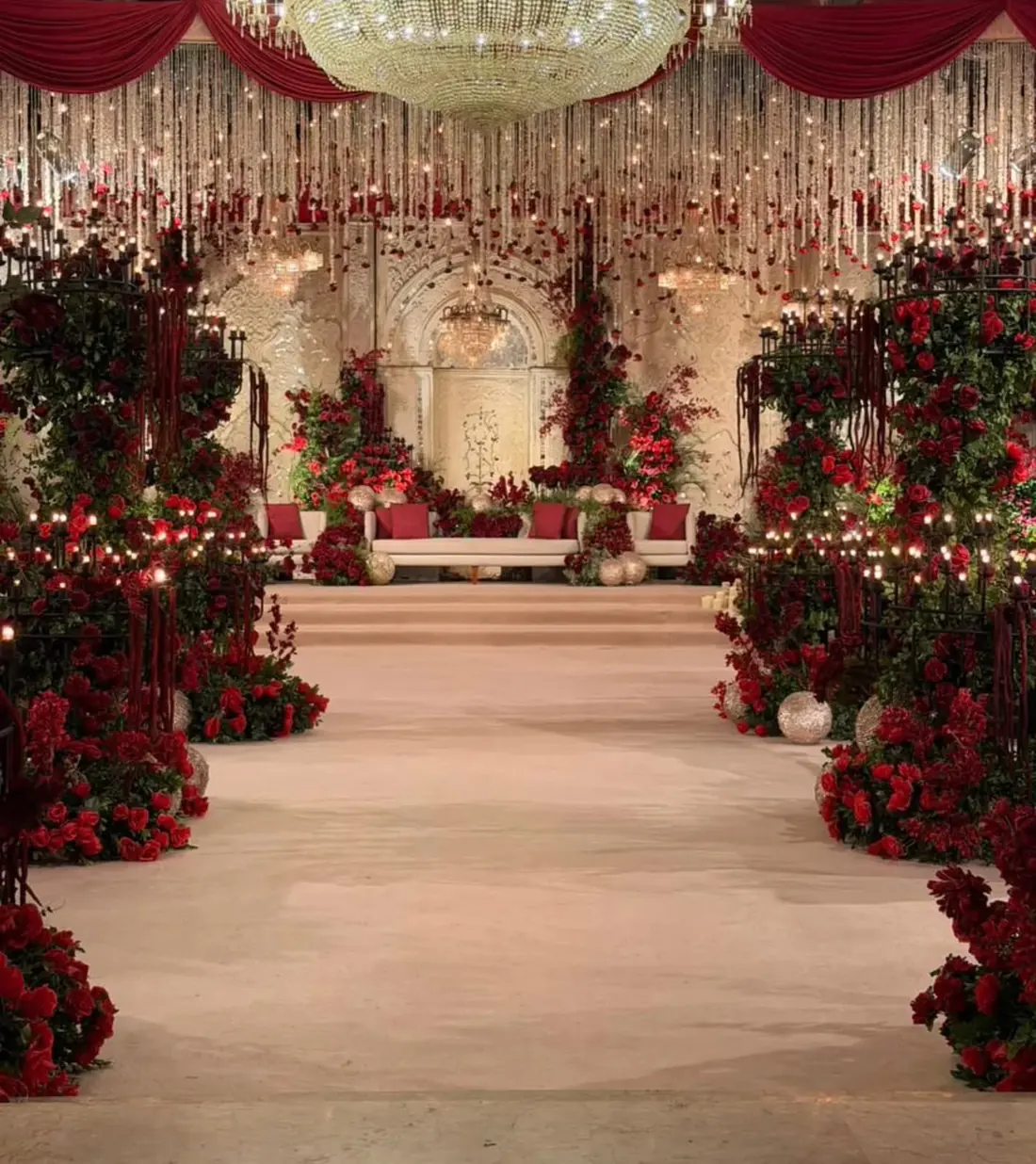 Red rose aisle with candle stands by Events by OT